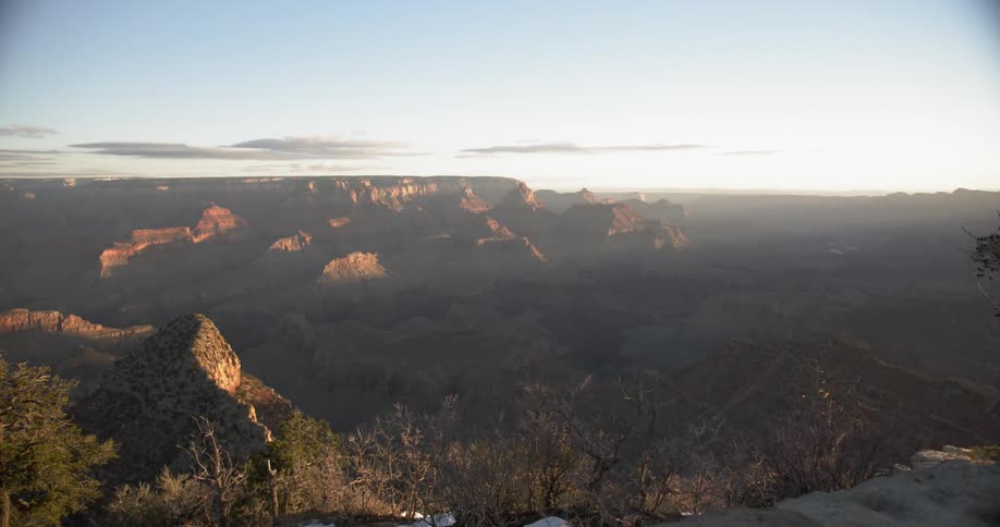 The sky is clear with slight fog over the mountains