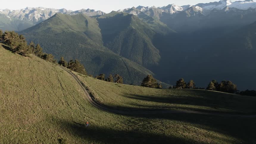 A person is running on the green hills of the mountain