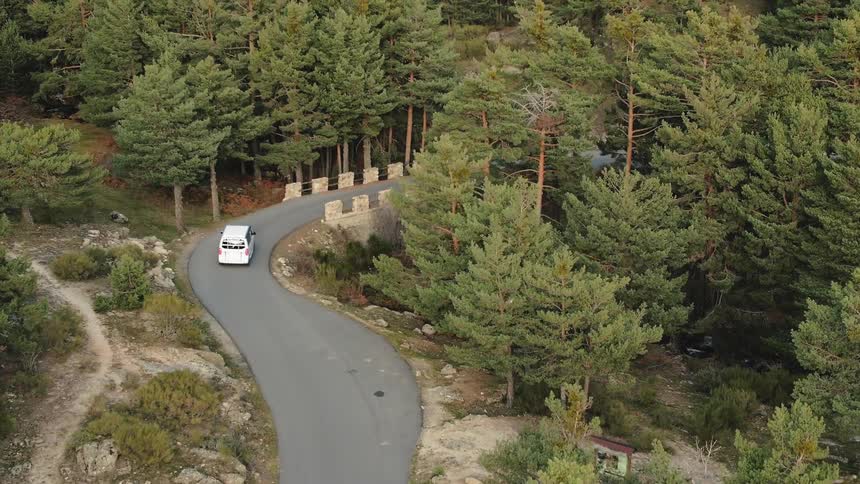 A white van turns around the road