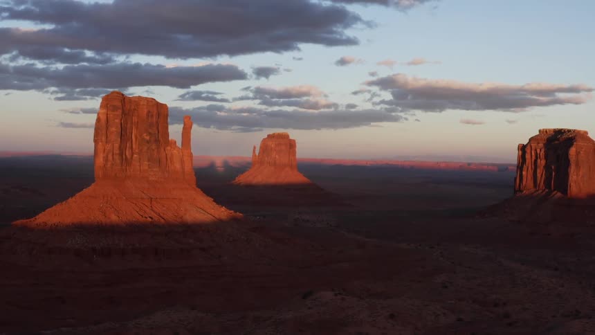The setting sun shines on tall rock formations