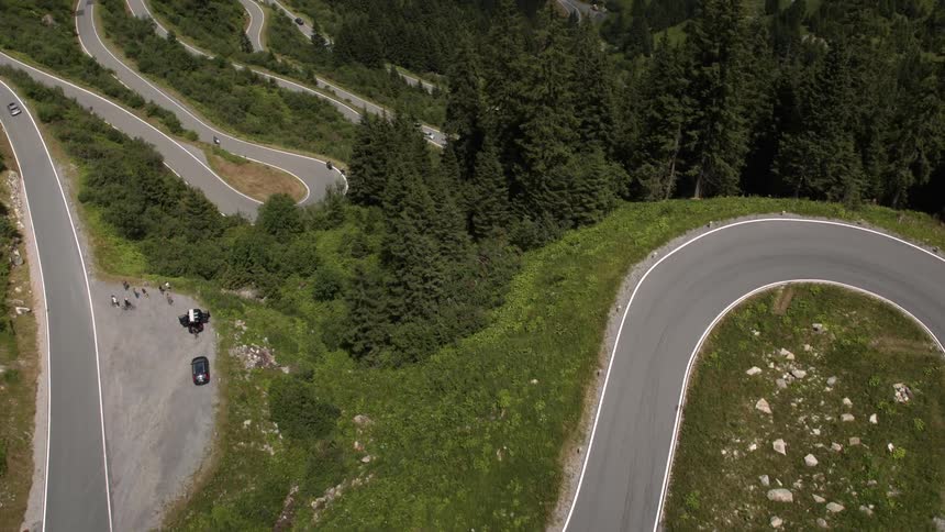 People are driving around the winding roads below