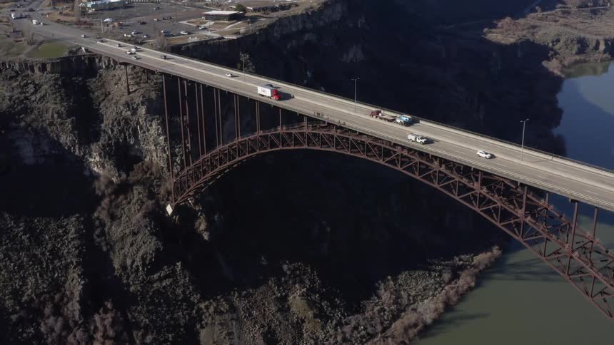 Vehicles pass over the canyon bridge