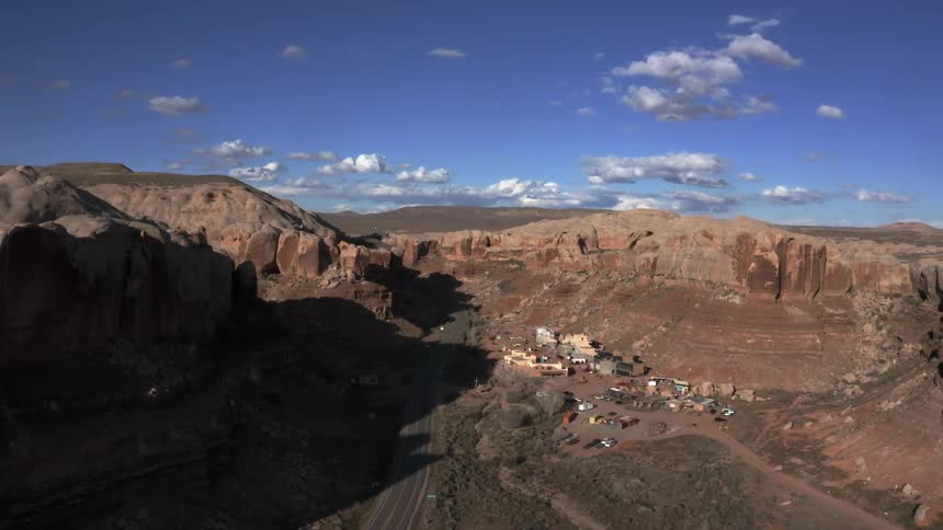 Aerial of small desert town surrounded by red rocks
