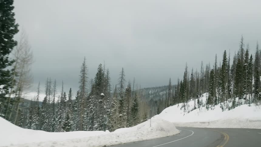 The winding road is surrounded by snow