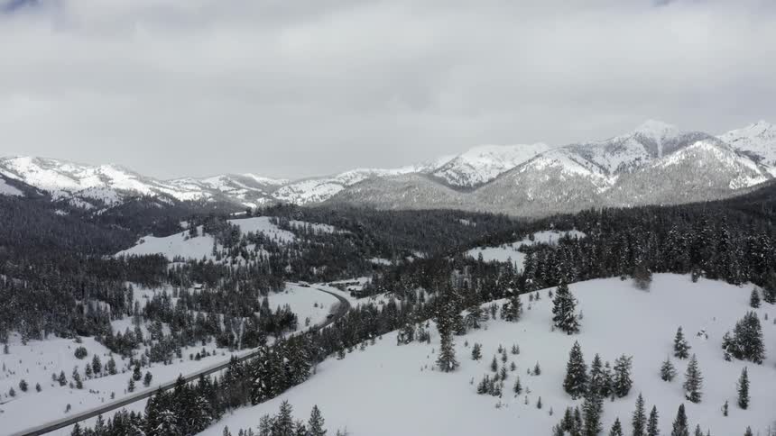 Highway through snowy mountain valley