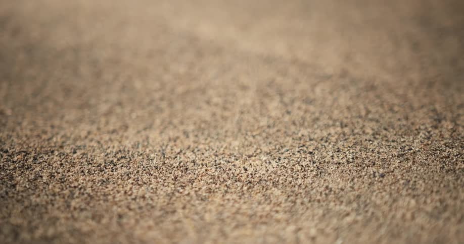 Macro shot of sand particles moving