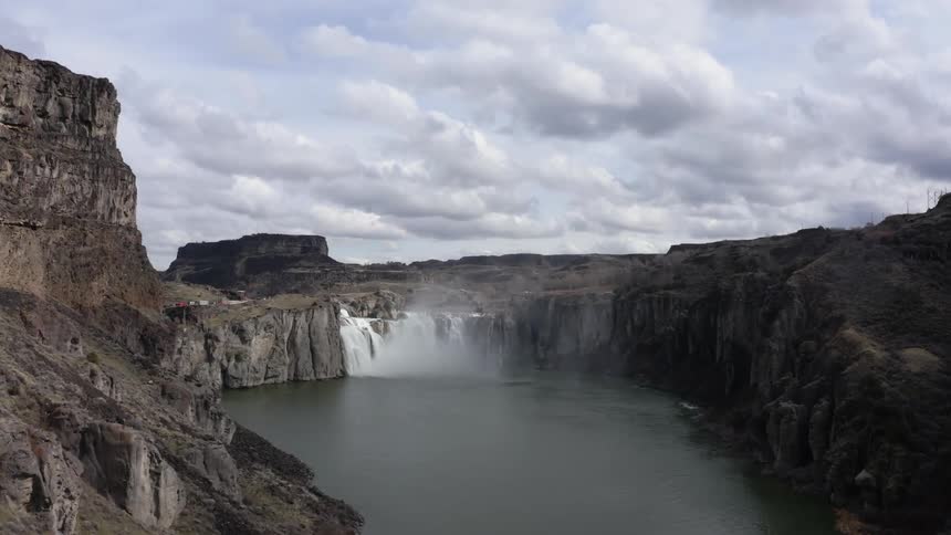 Large waterfall splashes and mists into a pool below