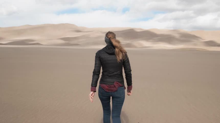 Woman exploring sand dunes in the desert