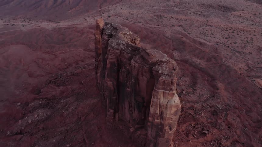 A rock formation stands in the desert