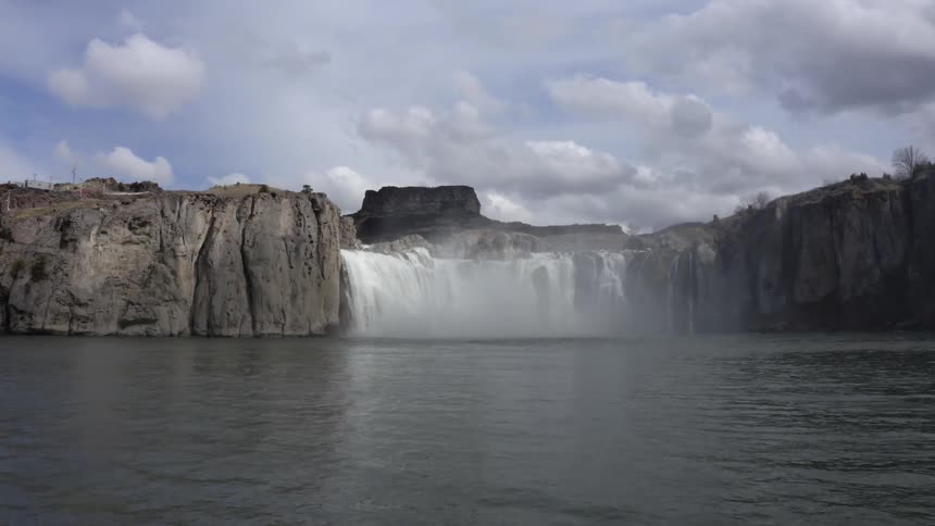 A waterfall flows over a cliff