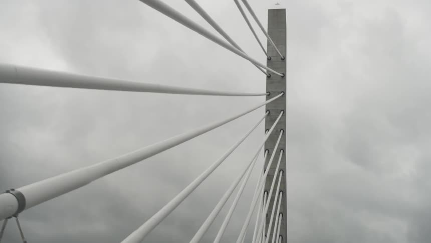Bridge like spokes extend out of a metal support on an overcast day
