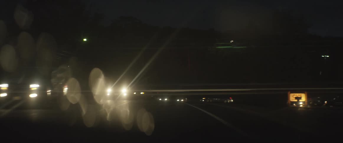 Cars travel on a road at night