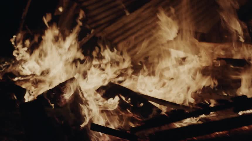 A fire burns a house