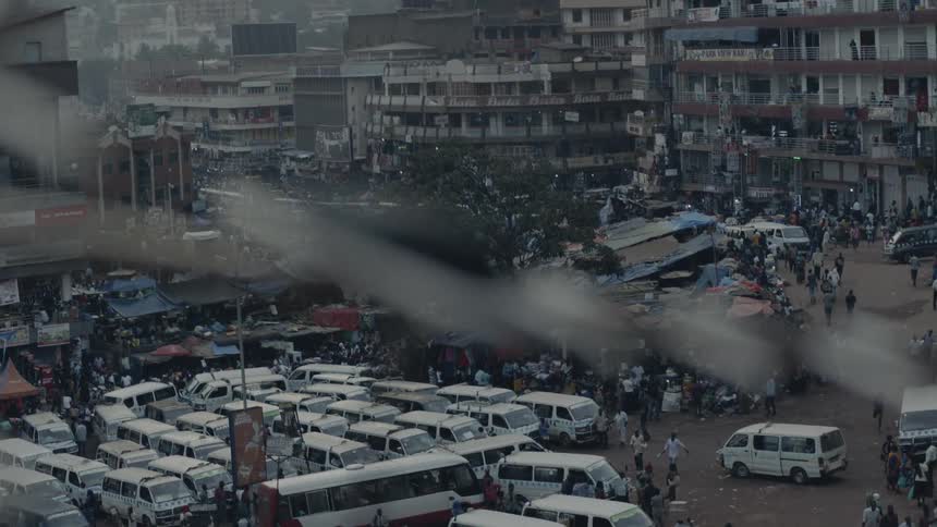 Vans and pedestrians cover a city parking lot