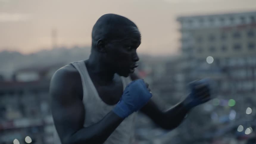 Man boxing on top of building