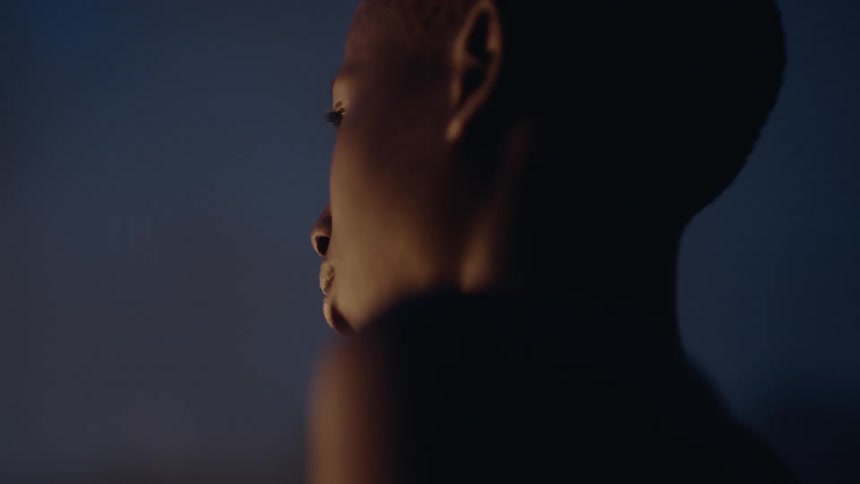 Child stands outside at night as a glow washes over him