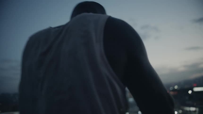 Man punches the air at dusk