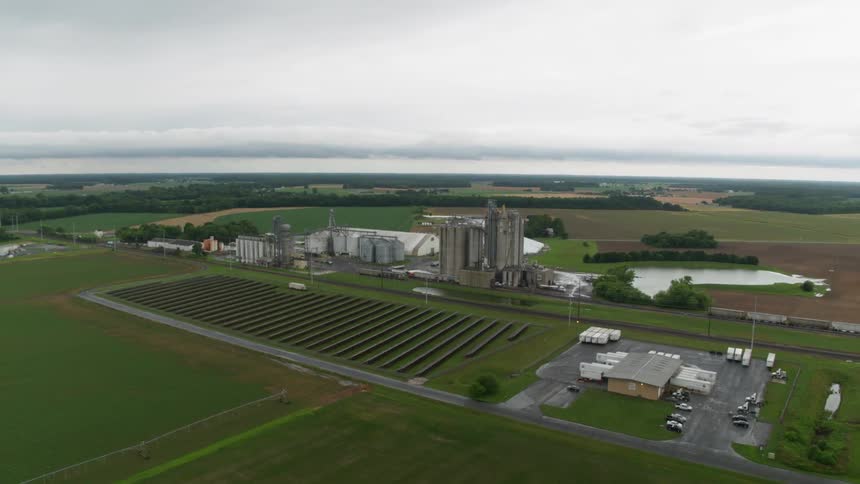 Vast area of farmland with crops and buildings