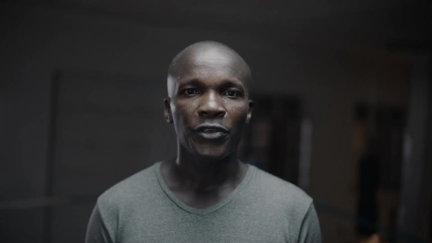 A man is standing in a room and saying thank you