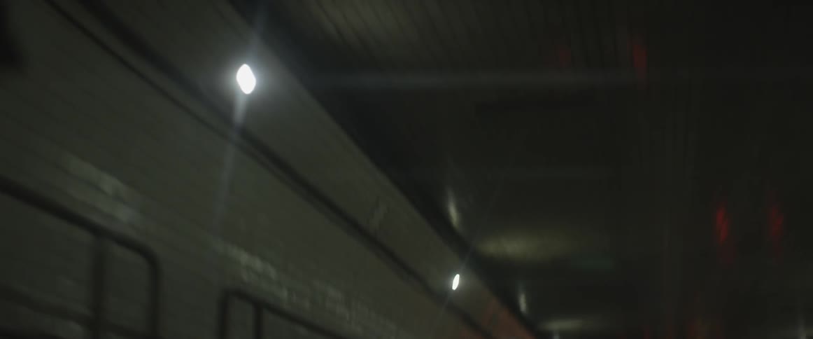 Driving through a tunnel looking up at the ceiling and passing lights