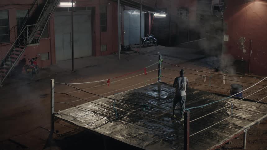 Man boxing alone outside at night