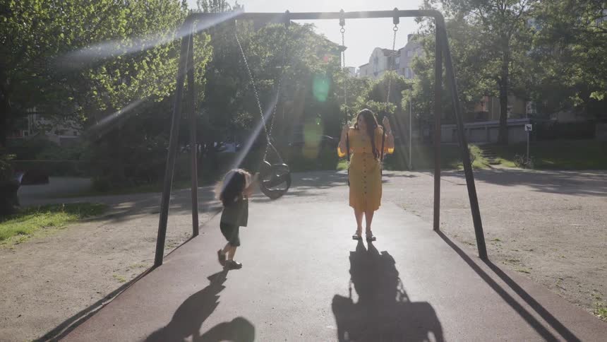 Woman and child on swing set