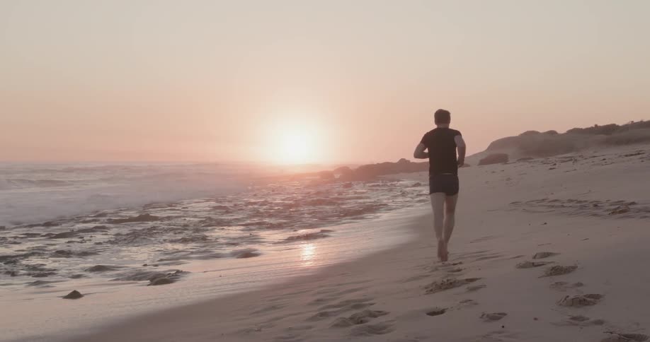Man jogs along the beach