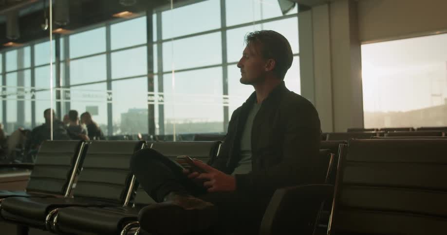 Man sits waiting in airport terminal