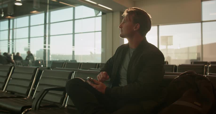 Man uses his phone in an airport