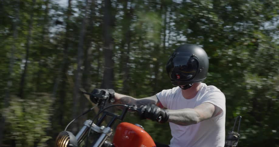 Man is riding motorcycle on sunny day