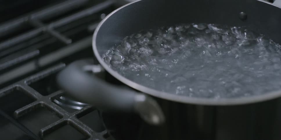 Water boils in a pot on the stove