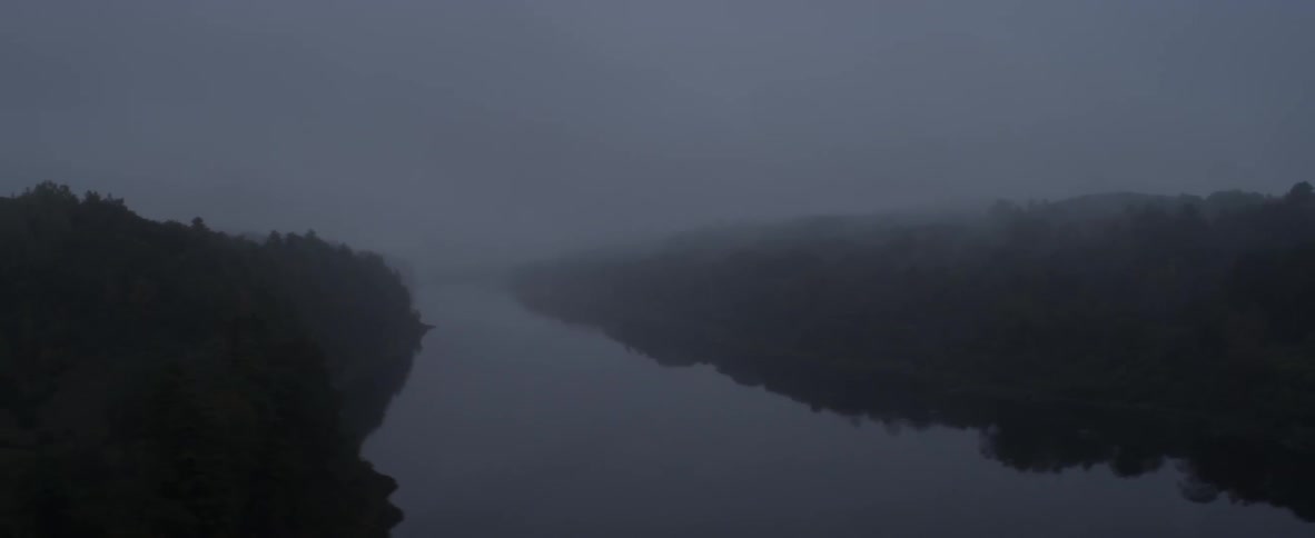 Fog hangs over a river