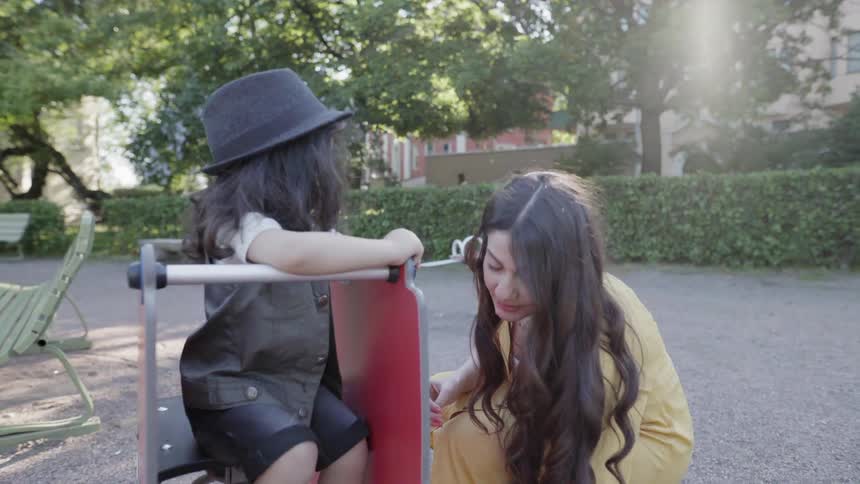 Woman and child play at a park