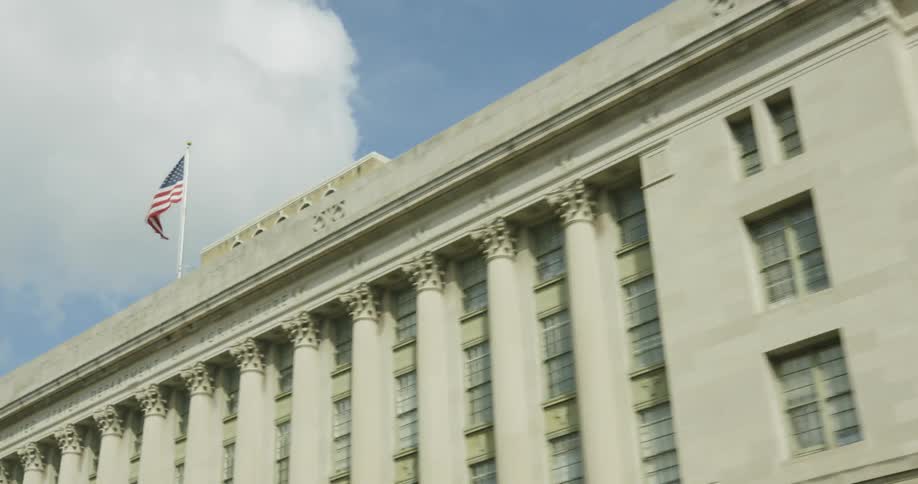 An american flag billows on a large building