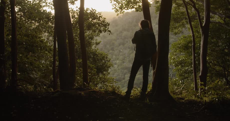 Man takes a photograph while hiking in mountains