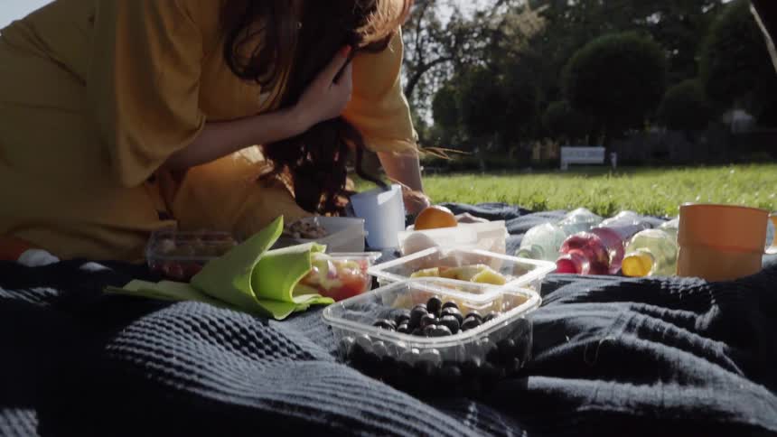 A woman and child picnic on a sunny day