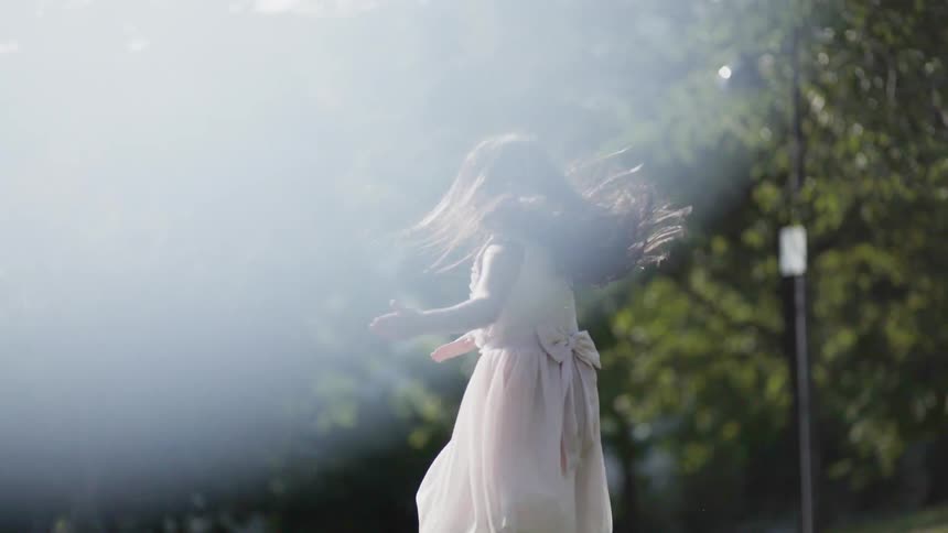 A girl spins in a park