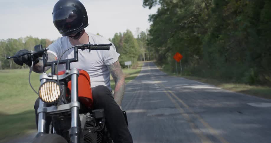 Man motorcycles on a rural road