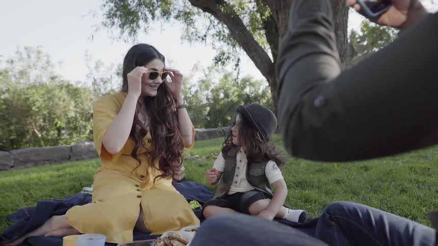 A family picnics in a park