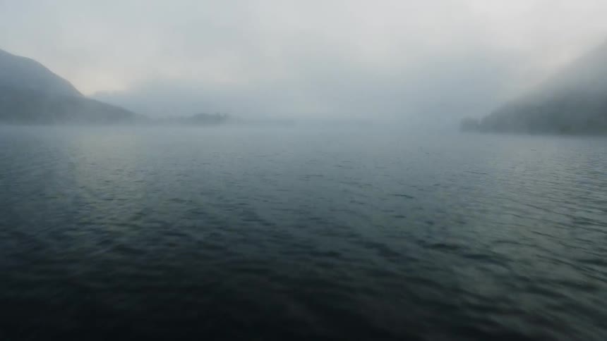 Mist floats above a mountain lake