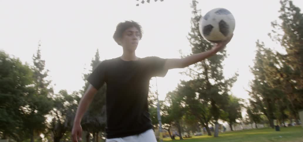A young man kicks a soccer ball