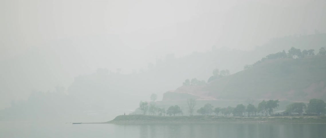 Mist floats over the water and hills