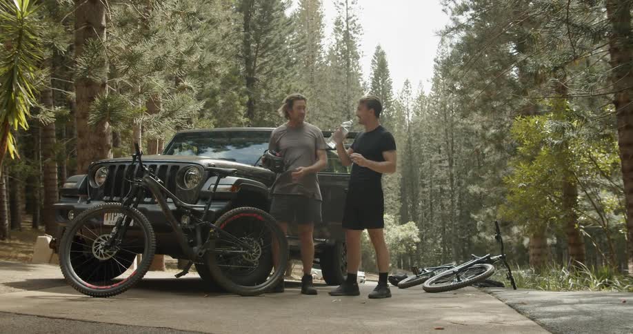 Two men enjoy a bike ride in a forest