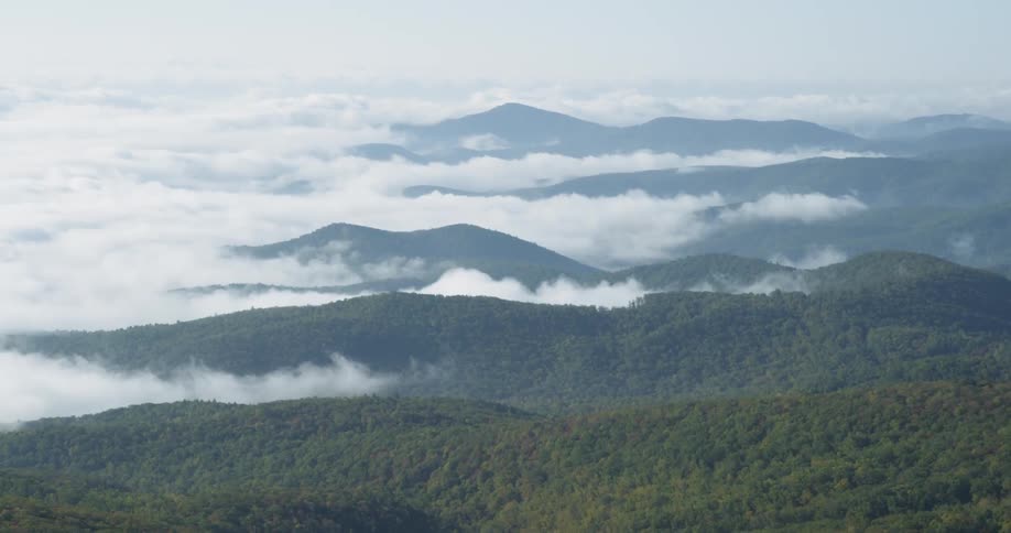 Clouds float over mountains in the wilderness
