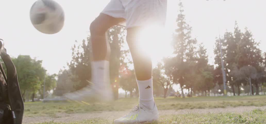 A young man kicks a soccer ball