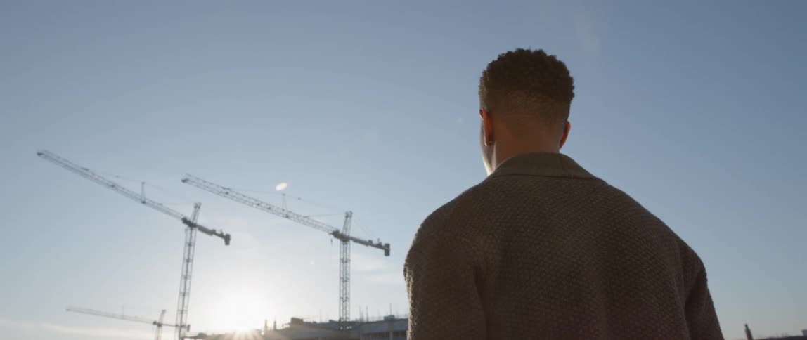 A man looks out to a construction site