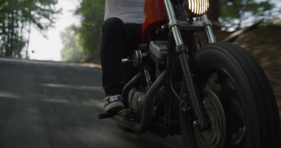 A motorcyclist rides on a rural road