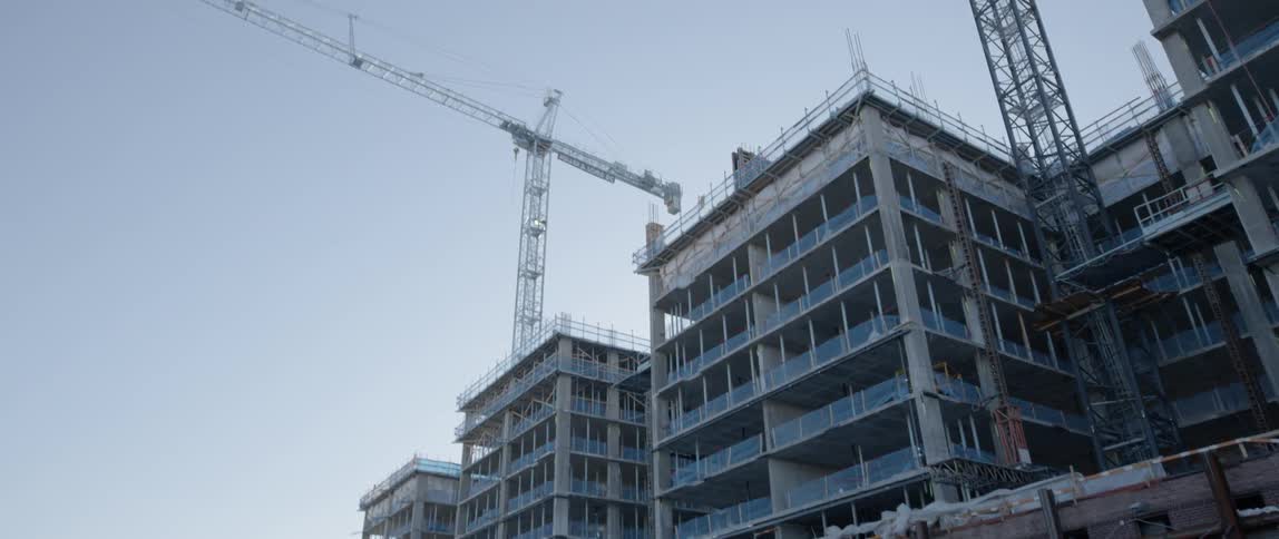 Cranes construct a city building