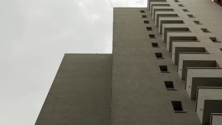 Tall city apartment building on cloudy day