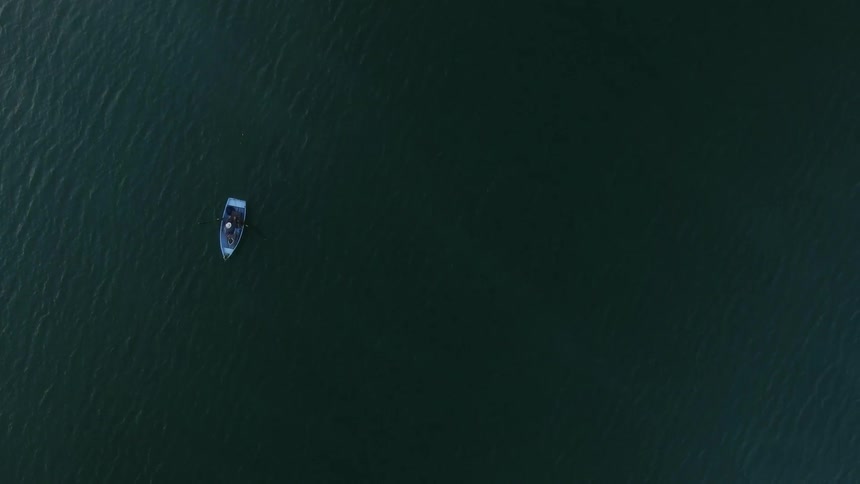 A boat floats on a lake